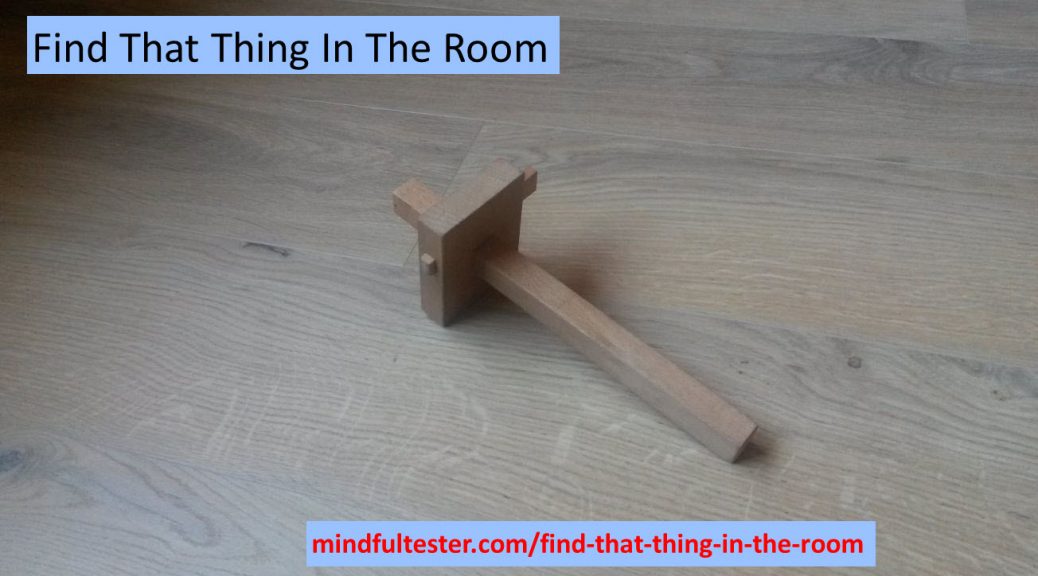 A carpenter s' tool on the floor. Also containing texts “Find That Thing In The Room” and “mindfultester.com/find-that-thing-in-the-room”!